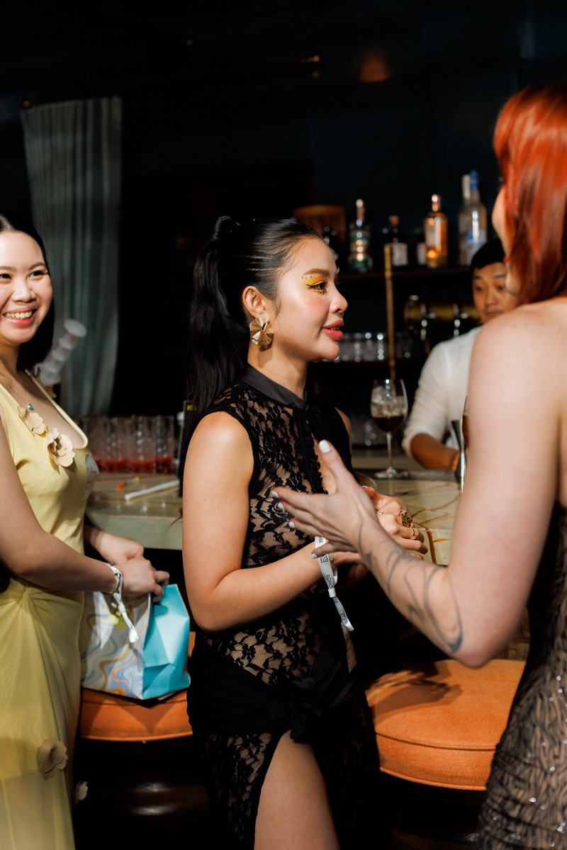 Guests chatting at the bar during the Full Moon Peptide Party